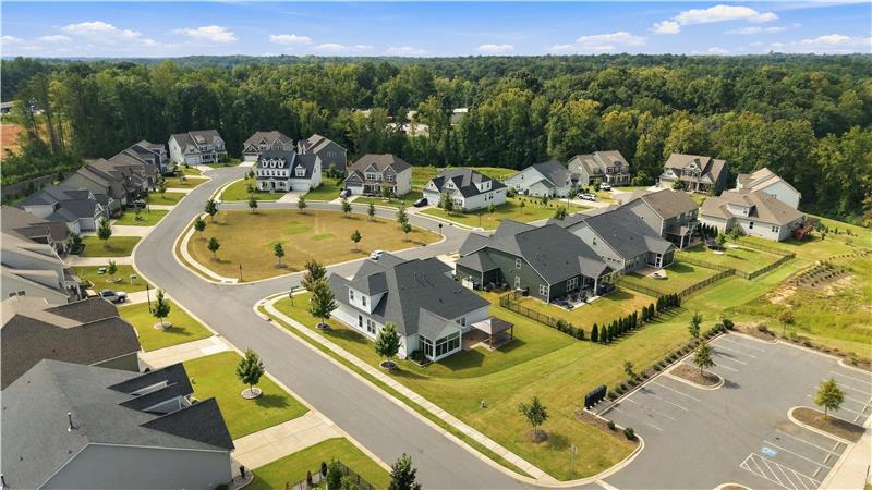 Aerial view of the corner home situated at the start of two cul-de-sac streets across from common space.