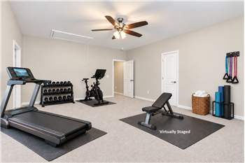 Flexible floor plan: one of two spacious bedrooms on home's upper floor, virtually staged as a home gym.