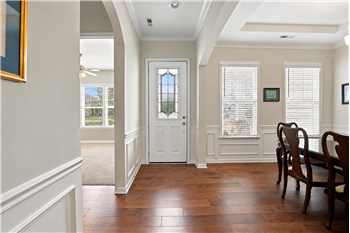 Inviting entry with hardwood floors, detailed millwork, graceful archways and an elegant leaded-glass front door.