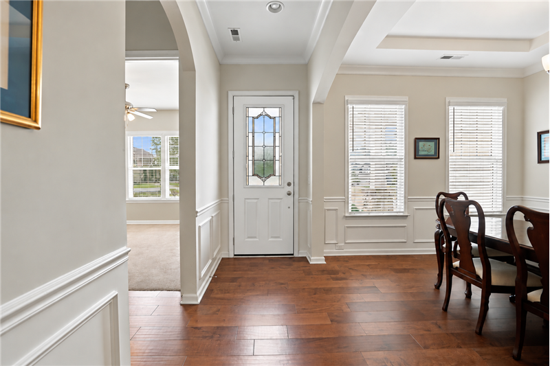 Inviting entry with hardwood floors, detailed millwork, graceful archways and an elegant leaded-glass front door.