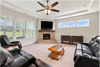 Great room designed to live large, with 10 foot trey ceiling, wall of windows, gas log stone fireplace as its focal point.