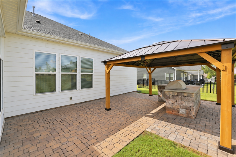 Patio area with built-in grilling center, custom gazebo, brick pavers extend the home's living and entertaining space.