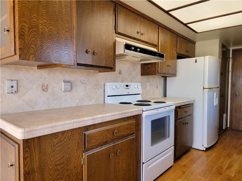 Cabinets constructed of actual wood and a matching tile backsplash is a welcomed sight!