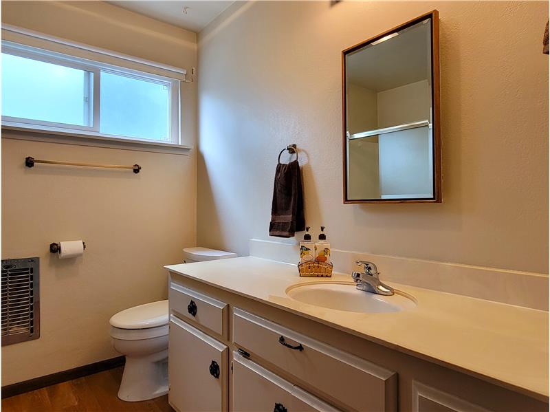 Perfectly positioned between Bedrooms 2 and 3 is the Main Bath with solid surface counters.