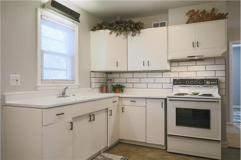 Kitchen with new tile backsplash