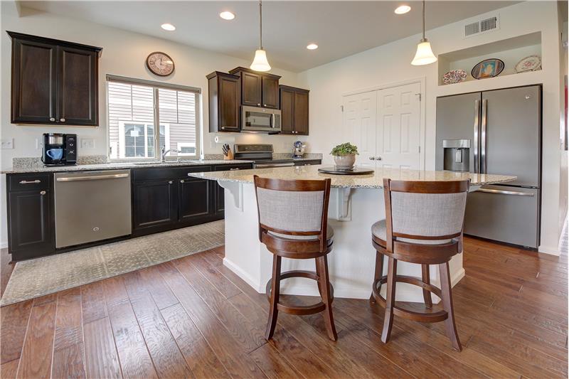 Expansive Kitchen comes complete w/slate appliances, espresso-stained cabinets w/granite counters & pull-out shelves