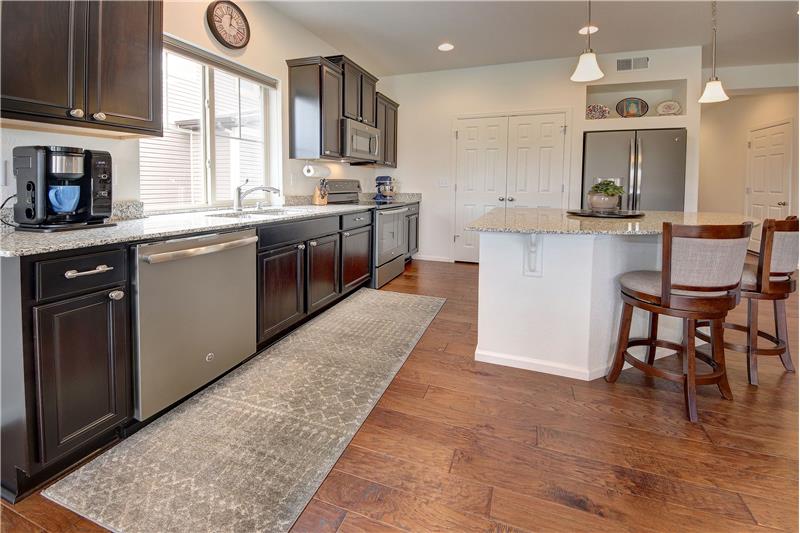 Another view of the gourmet Kitchen with espresso-stained cabinets and upgraded granite counters