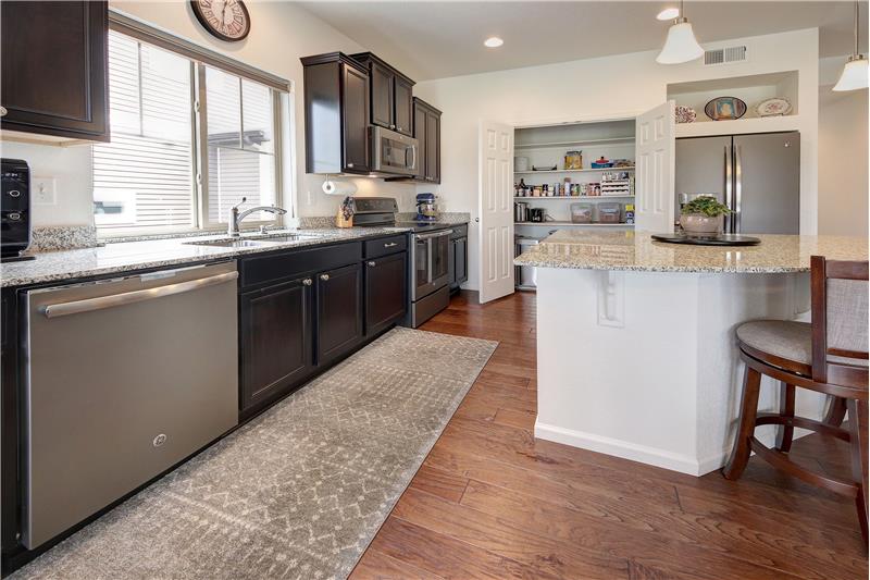 Large kitchen pantry with wood shelves