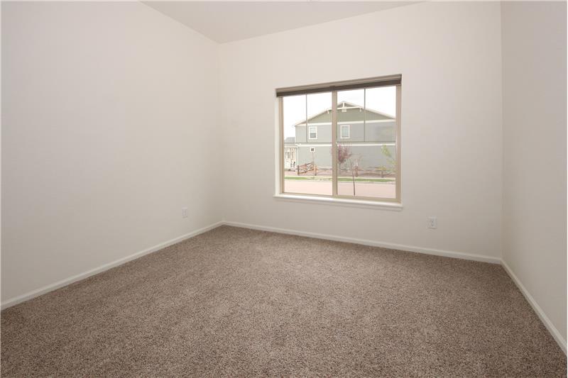 Main level front Bedroom with neutral carpet