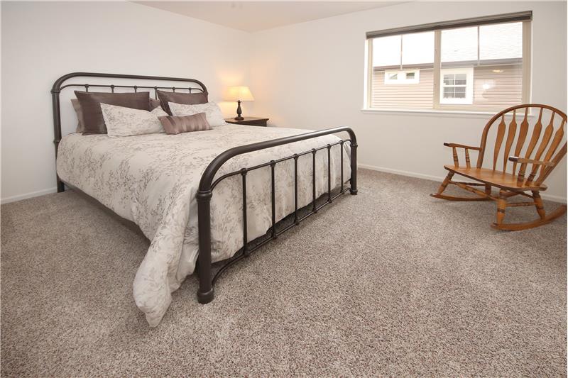 Large upper-level Bedroom with neutral carpet, a lighted ceiling fan, and an ensuite bathroom