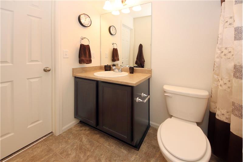 Ensuite Bathroom with vanity and tiled tub/shower and walk-in closet