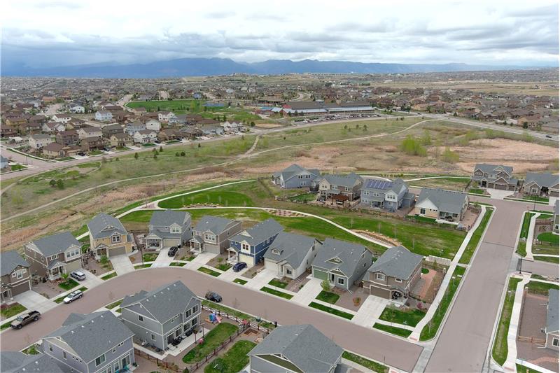 Another aerial view of the home, open space and trails