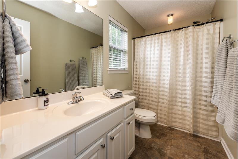 En-suite, windowed owner's bathroom with extended vanity and soaking tub/shower combination.