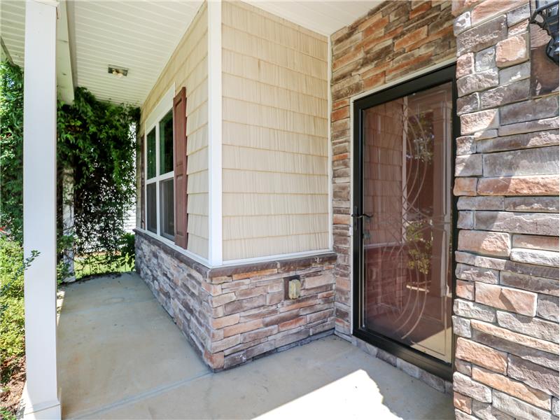 Pretty stone and vinyl shingle accents at front porch