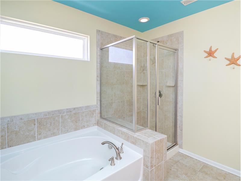 Tile shower, tub surround and floor in primary bath