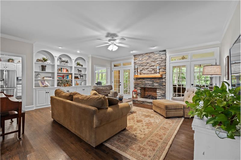 Spacious great room with two sets of double French doors leading to screened porch.