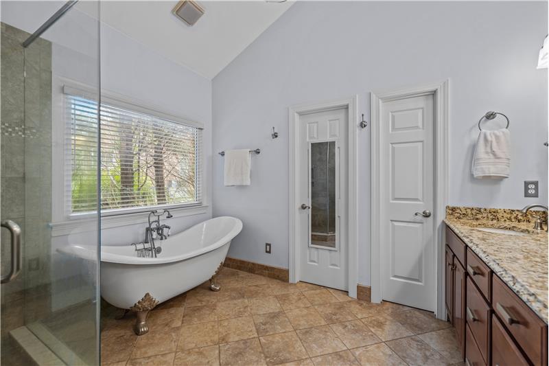 Large picture window over tub provides natural light and beautiful wooded views.