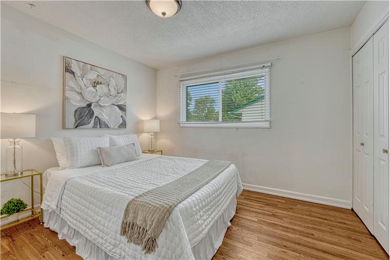 Primary bedroom with hardwood flooring