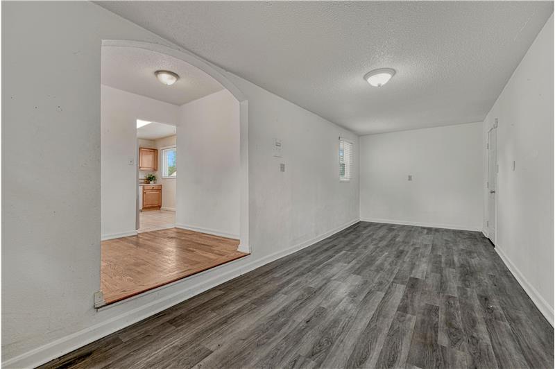 Flex space with laminate flooring can be used as an office or family room and offers a separate walk out to the front yard