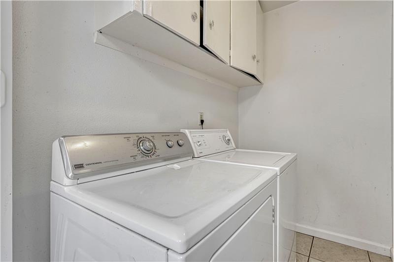 Laundry room with cabinets. Washer and Dryer stay!