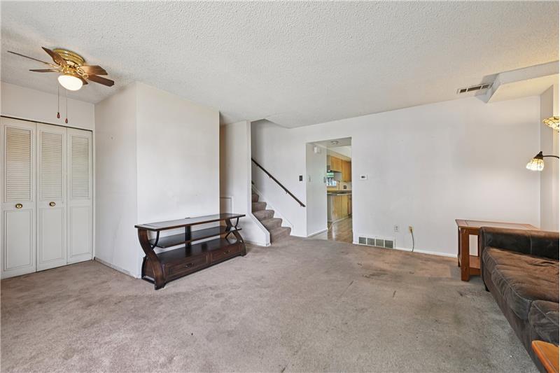 Living room with kitchen/dining room beyond