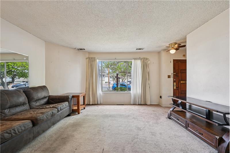View of living room from door to kitchen/dining room.