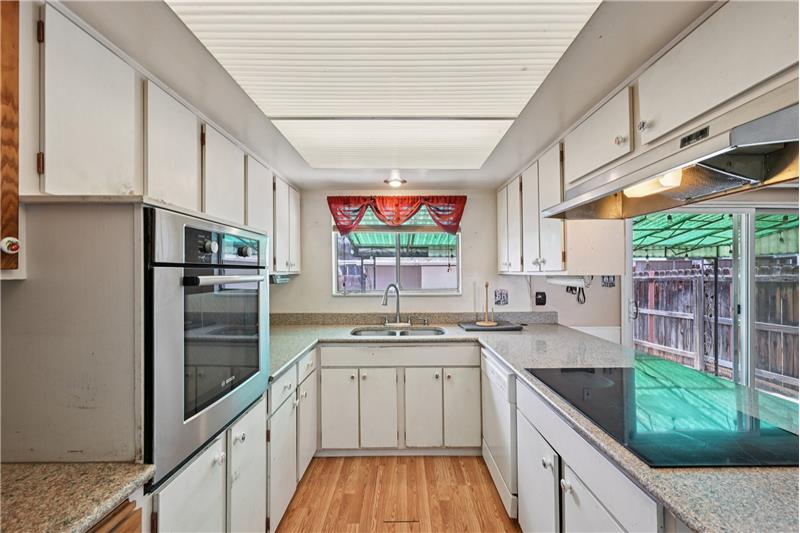 White dishwasher is to right of kitchen sink