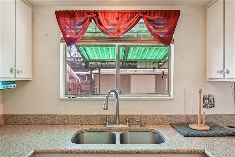 View of covered patio through kitchen window