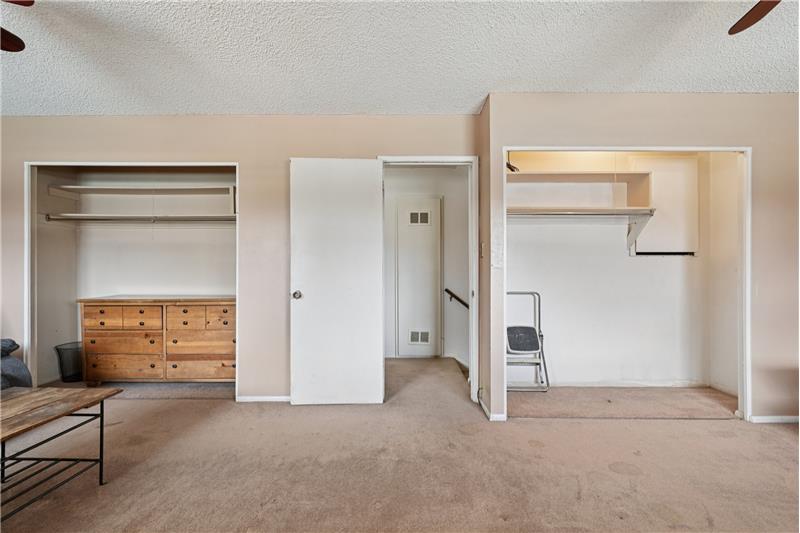 The 22-foot-wide bedroom upstairs used to be two bedrooms. Note the two closets. Just add a 2nd door from the landing