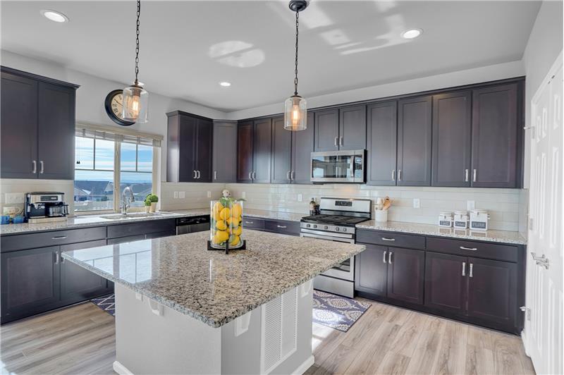 Gourmet Island Kitchen with granite countertop and pendant lights