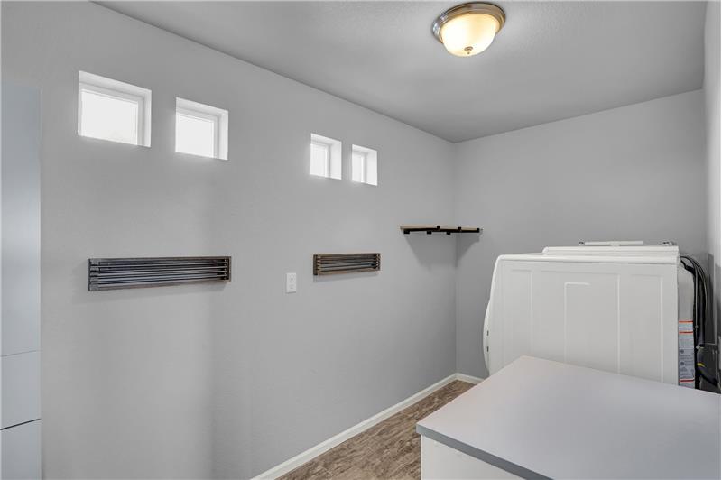 Upper Level Laundry Room with storage cabinet