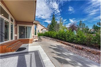 Backyard patio with lots of trees for privacy and shade.