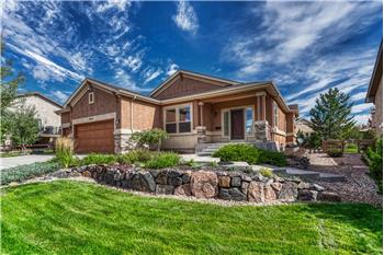 Great curb appeal with beautiful professional landscaping and raised rock planting bed.