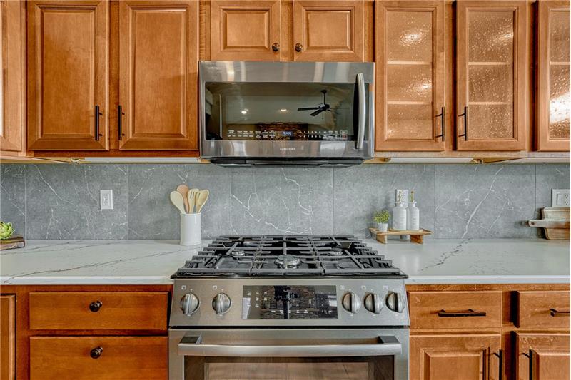 The Kitchen offers a Bosch gas range oven and built-in microwave oven.