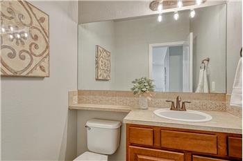 Main level Powder Bathroom with vanity and mirror.