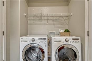 The main level Laundry Room includes the washer and driver.