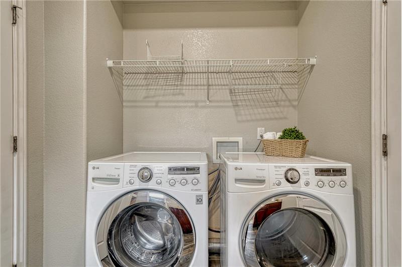 The main level Laundry Room includes the washer and driver.