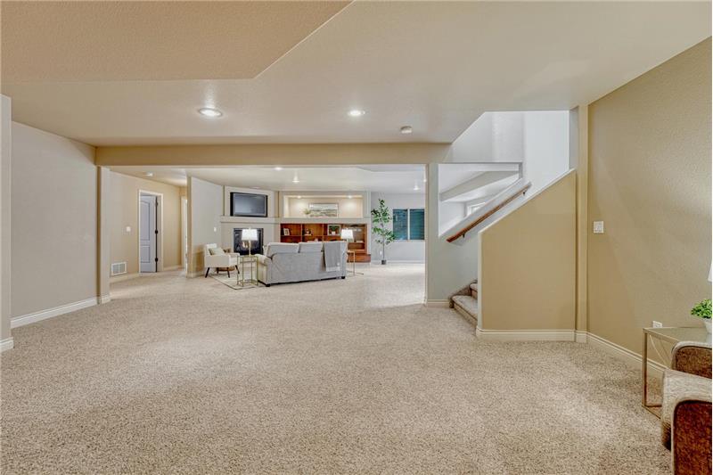 The basement expands the living space with a large family room featuring a fireplace, built-in entertainment center, & wet bar.