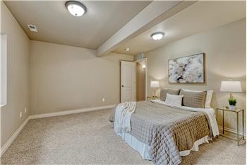 Basement Bedroom #3 with neutral carpet.