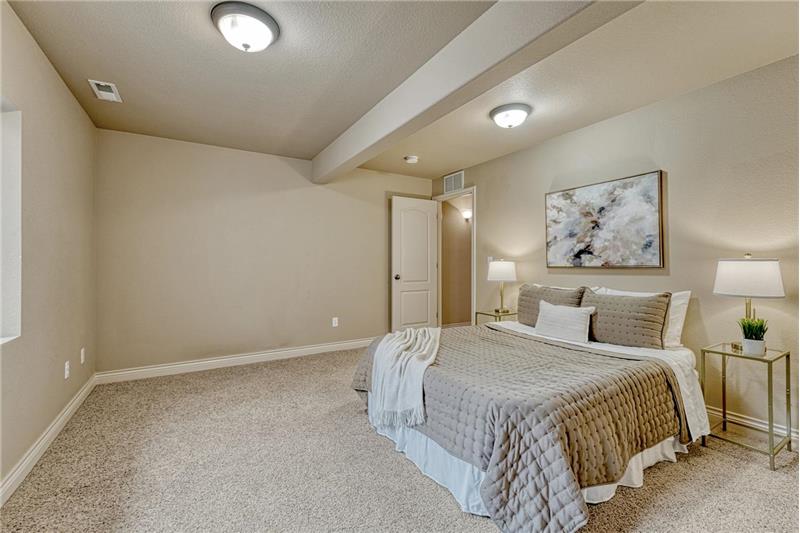 Basement Bedroom #3 with neutral carpet.