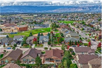 Aerial view of the rear of the home and neighborhood including Ranch Creek Elementary School.