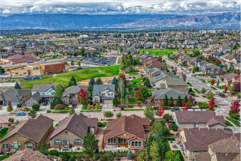Aerial view of the rear of the home and neighborhood including Ranch Creek Elementary School.