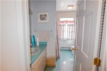 First floor bathroom.  Vanity with green tile