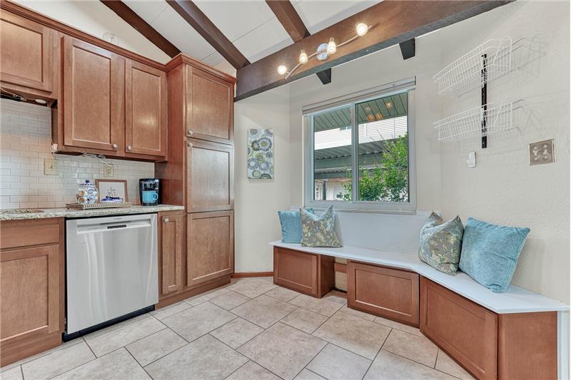 Remodeled kitchen with updated cabinetry, cabinet pantry, built-in bench with storage, and new dishwasher!