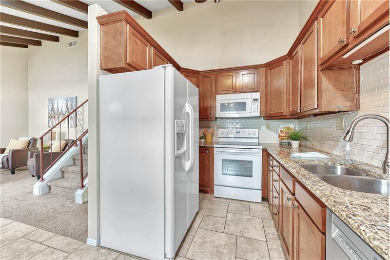 All appliances included! Granite counters, tile backsplash, tile flooring, and under cabinet lighting
