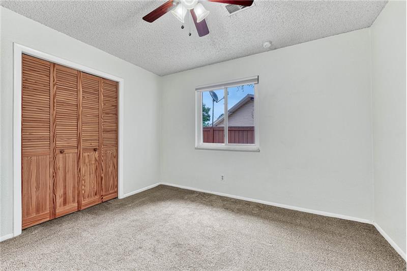 Lower level bedroom is nice and bright and has a large closet with built-in shelving!