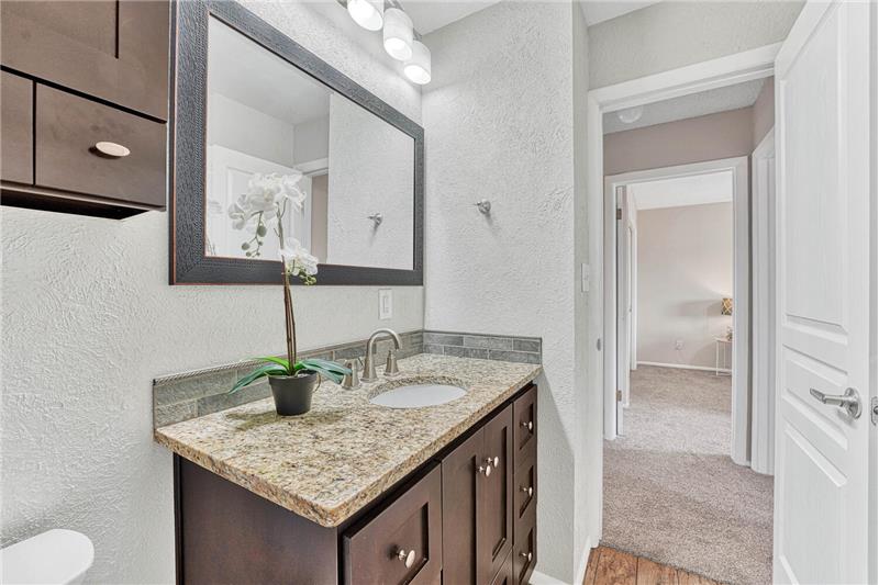 Upper level full bath with new comfort height vanity with granite counter and undermount sink, tile backsplash, and new lighting