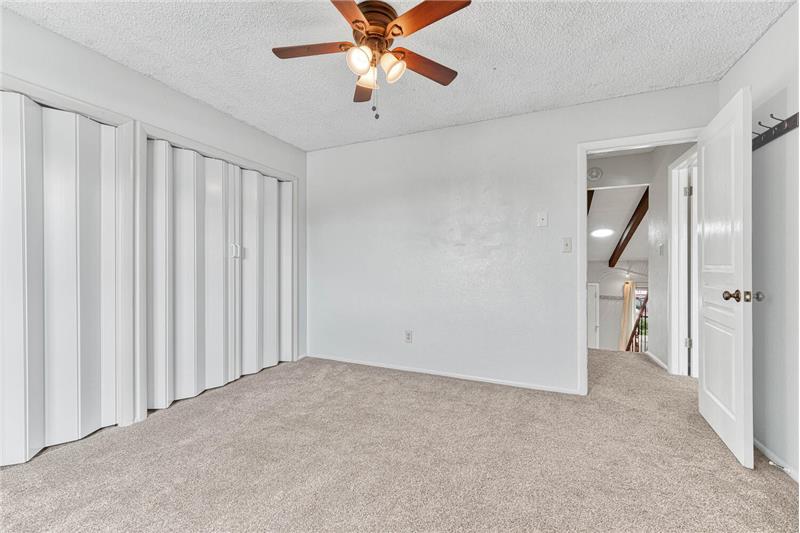 Ceiling fan, neutral carpet, and blackout cellular blinds