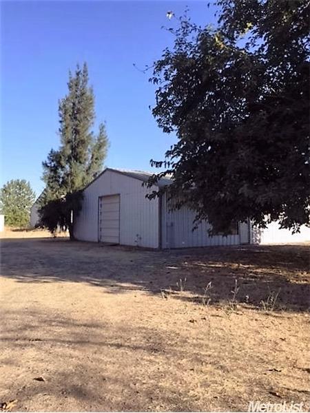 Barn with stalls and roll-up doors.