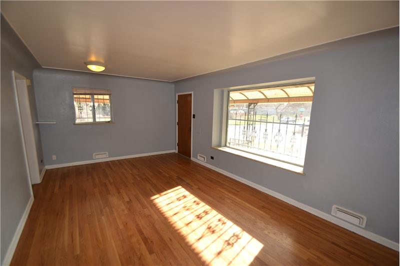 Living room has large picture window facing street